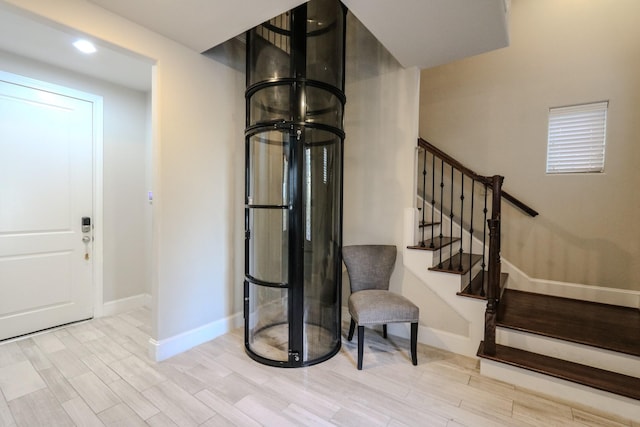 entryway featuring stairway, baseboards, and wood finished floors