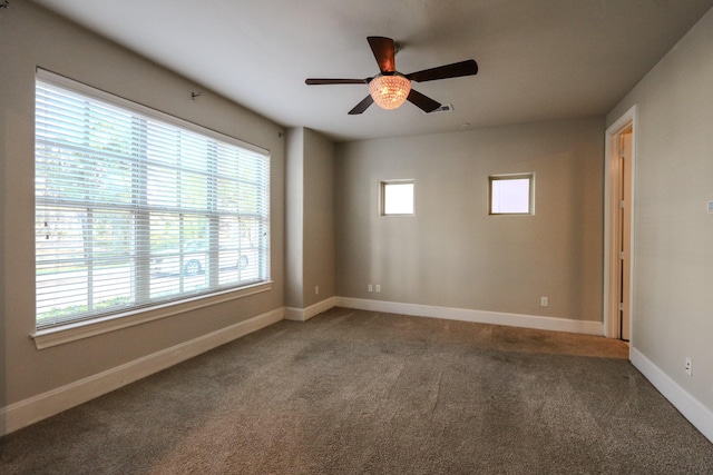 carpeted spare room with baseboards and a ceiling fan