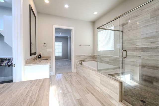 full bath featuring a garden tub, vanity, recessed lighting, a stall shower, and baseboards