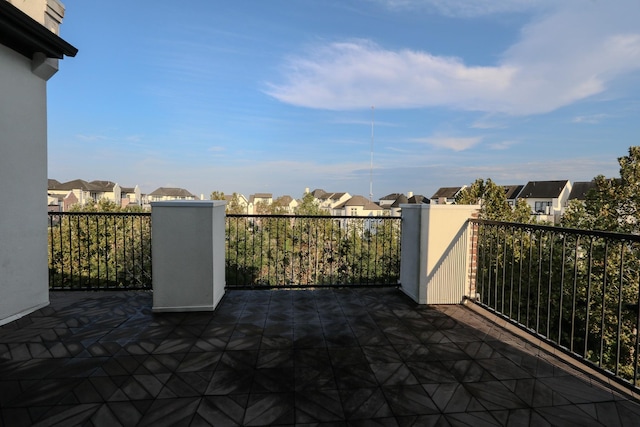 view of patio featuring a residential view and a balcony