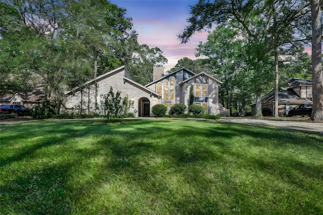 view of front of property featuring a front lawn and a chimney
