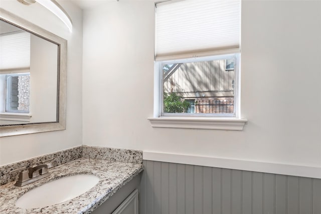 bathroom with a wainscoted wall and vanity