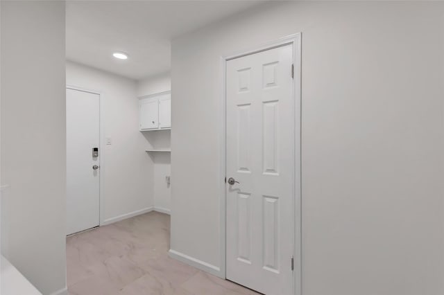 clothes washing area with recessed lighting, marble finish floor, and baseboards
