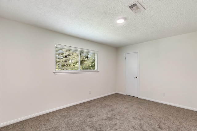 unfurnished room featuring baseboards, visible vents, a textured ceiling, and light colored carpet