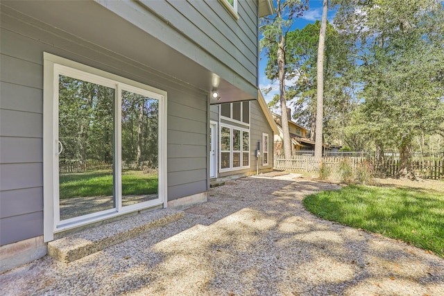 view of side of property featuring fence and a patio area