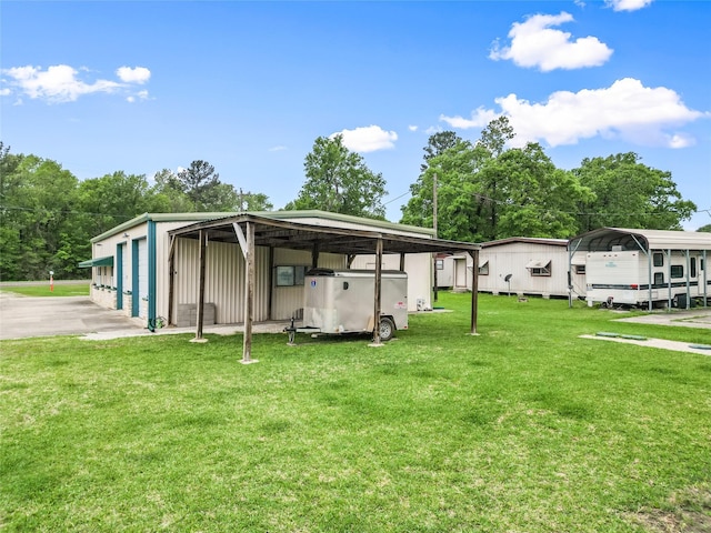 exterior space with a detached carport, an outdoor structure, and a lawn