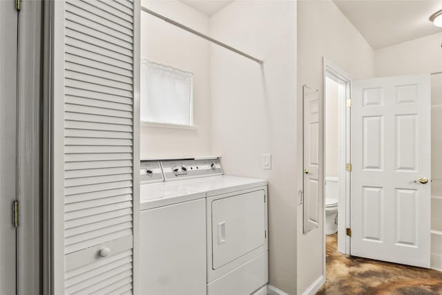 clothes washing area with washing machine and dryer and laundry area