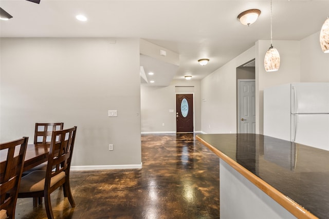 foyer with concrete flooring, baseboards, and recessed lighting