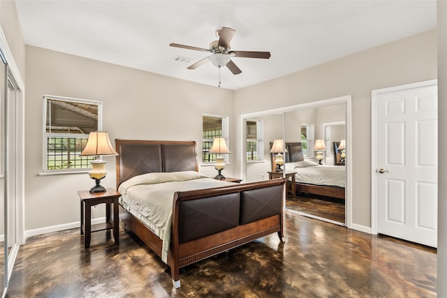 bedroom featuring finished concrete floors, visible vents, a closet, and baseboards
