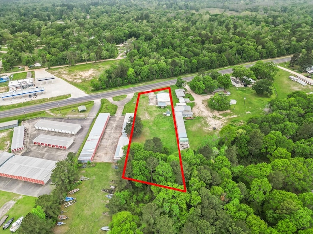 birds eye view of property featuring a view of trees