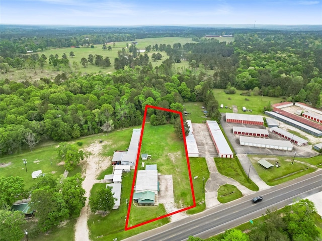 birds eye view of property with a wooded view