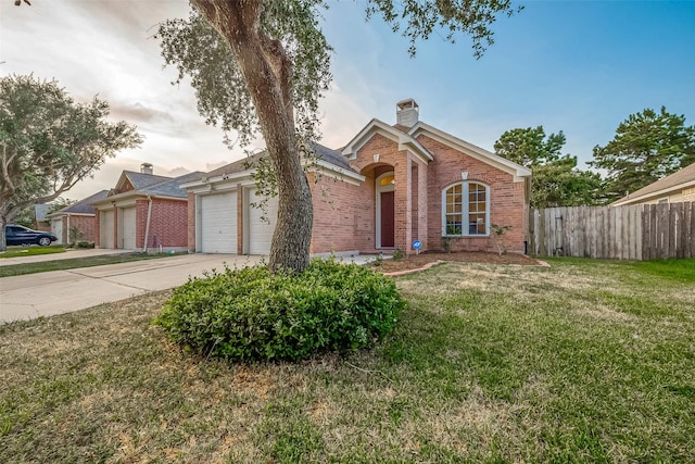 25910 Palmdale Estate Dr, Richmond, TX 77406 - view of front facade with an attached garage, fence, brick siding, a front lawn, and driveway