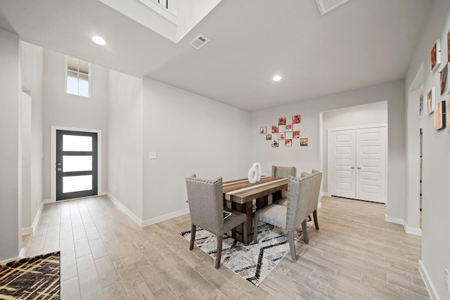 dining space with light wood-style floors, recessed lighting, and visible vents