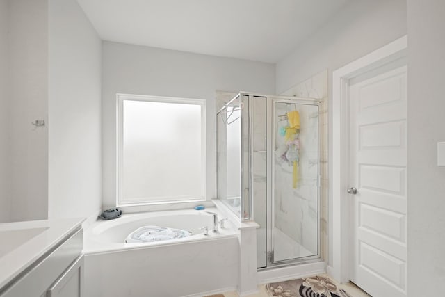 full bath with a bath, vanity, and a stall shower