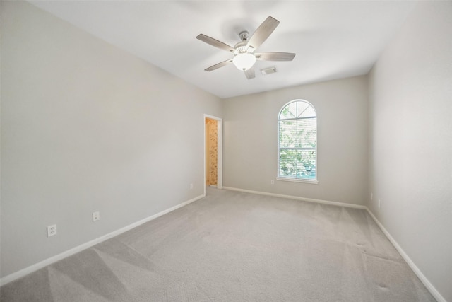 unfurnished room featuring light colored carpet, ceiling fan, baseboards, and visible vents