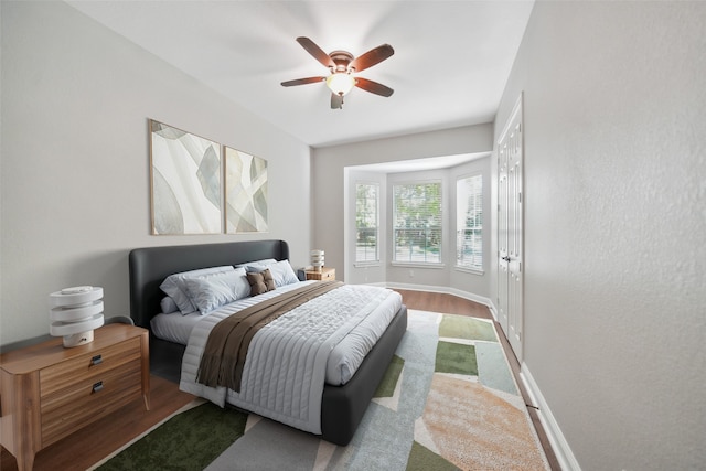 bedroom featuring baseboards, a ceiling fan, and carpet flooring