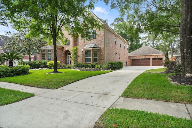 traditional-style house with brick siding, a front yard, and a garage