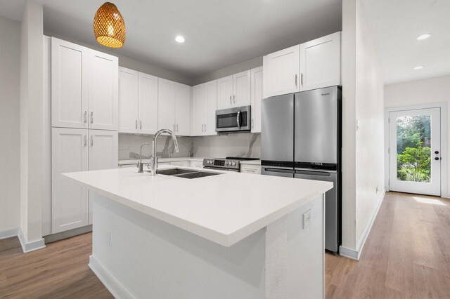 5710 Elysian St, Houston, TX 77009 - kitchen with stainless steel appliances, a sink, baseboards, light wood-type flooring, and recessed lighting