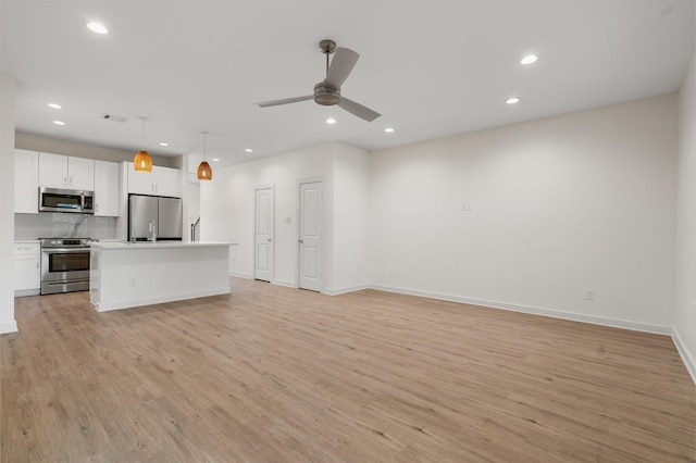 5710 Elysian St, Houston, TX 77009 - unfurnished living room featuring recessed lighting, light wood-style floors, baseboards, and a ceiling fan