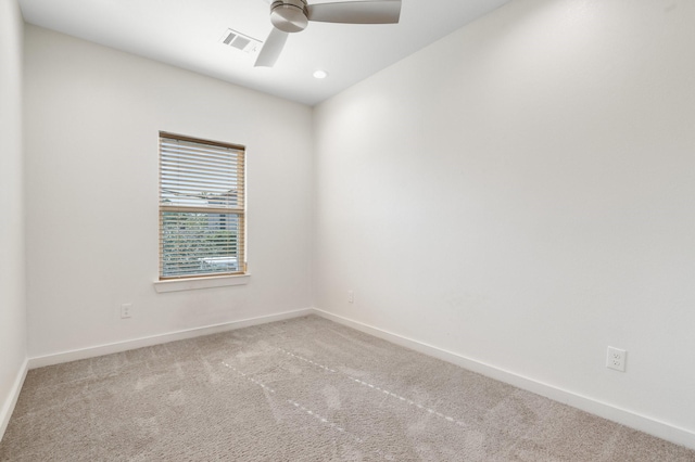empty room featuring a ceiling fan, baseboards, visible vents, and carpet