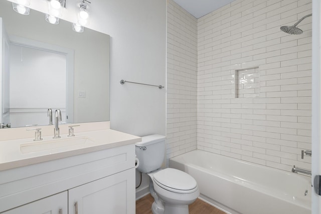5710 Elysian St, Houston, TX 77009 - bathroom featuring toilet, vanity, wood finished floors, and shower / washtub combination