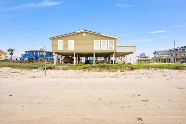 12802 Bermuda Beach Dr, Galveston, TX 77554 - rear view of house featuring a carport and stairway