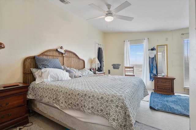 12802 Bermuda Beach Dr, Galveston, TX 77554 - bedroom with carpet, multiple windows, and a ceiling fan