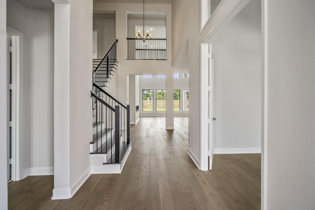 9618 Leafgate Ct, Missouri City, TX 77459 - foyer featuring baseboards, stairway, wood finished floors, a chandelier, and a high ceiling