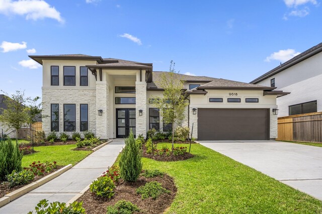 9618 Leafgate Ct, Missouri City, TX 77459 - prairie-style house with concrete driveway, stucco siding, an attached garage, and stone siding