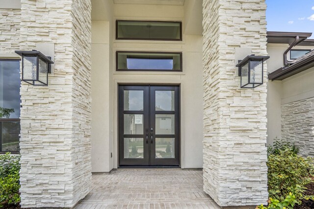9618 Leafgate Ct, Missouri City, TX 77459 - property entrance featuring french doors and stone siding