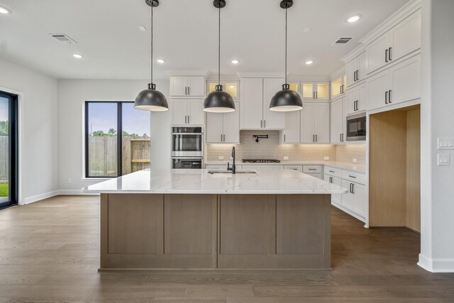 9618 Leafgate Ct, Missouri City, TX 77459 - kitchen featuring built in microwave, double oven, baseboards, white cabinets, and tasteful backsplash