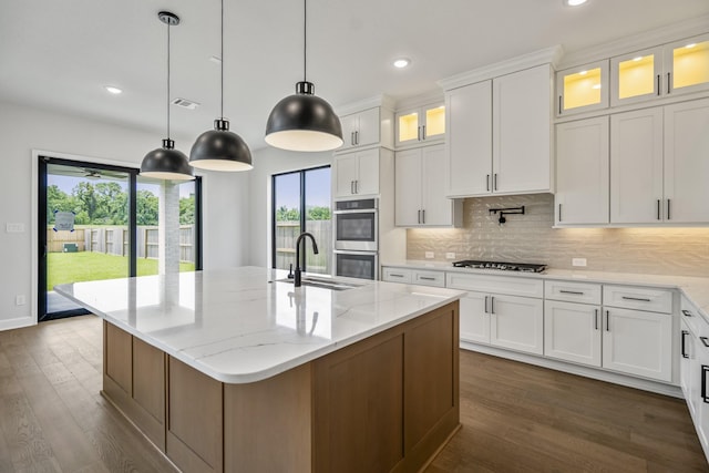 9618 Leafgate Ct, Missouri City, TX 77459 - kitchen featuring a sink, double oven, dark wood finished floors, backsplash, and recessed lighting