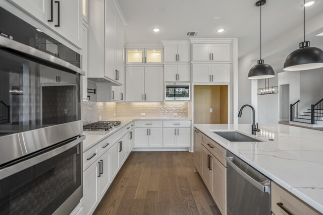 9618 Leafgate Ct, Missouri City, TX 77459 - kitchen with stainless steel appliances, a sink, recessed lighting, dark wood-style floors, and light stone counters