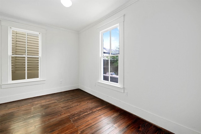 spare room with crown molding, baseboards, and dark wood-type flooring
