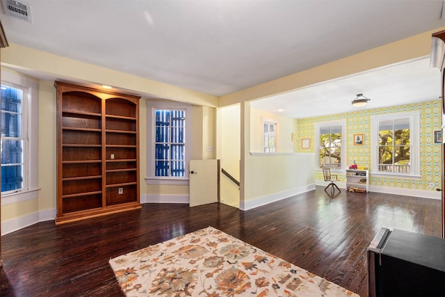 sitting room with wood-type flooring, baseboards, and visible vents