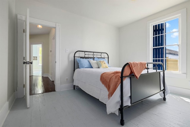 bedroom with baseboards and hardwood / wood-style floors