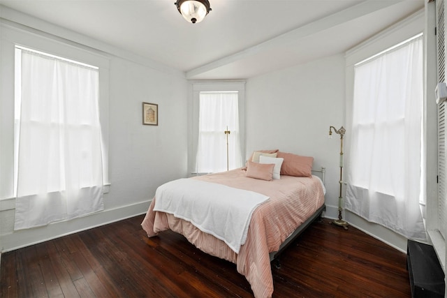 bedroom featuring baseboards and wood-type flooring