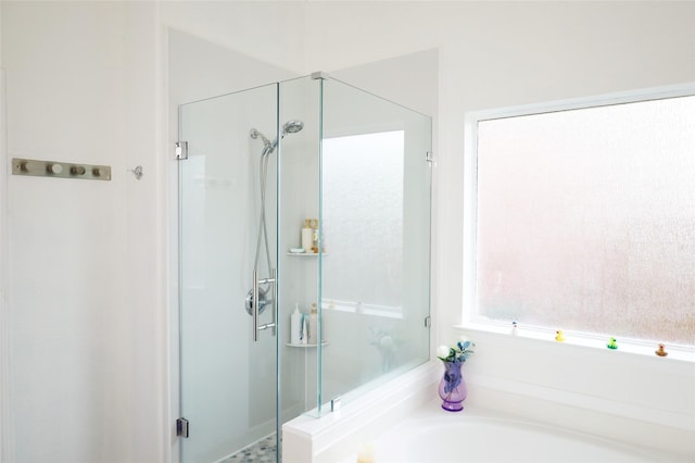full bathroom with a shower stall and a garden tub