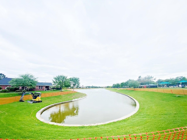 view of community with a water view and a yard