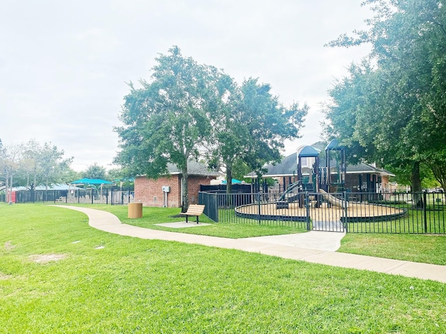 community play area with a yard and fence