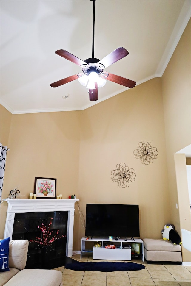 tiled living room with ceiling fan, ornamental molding, and a premium fireplace