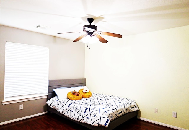 bedroom featuring baseboards, a ceiling fan, and wood finished floors