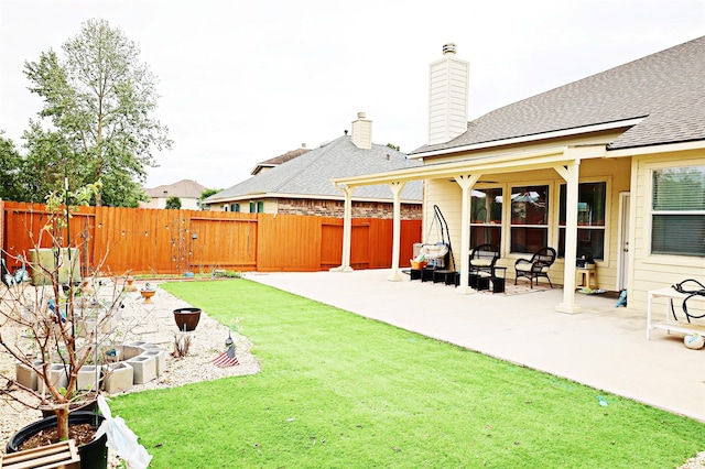 view of yard featuring a patio and fence