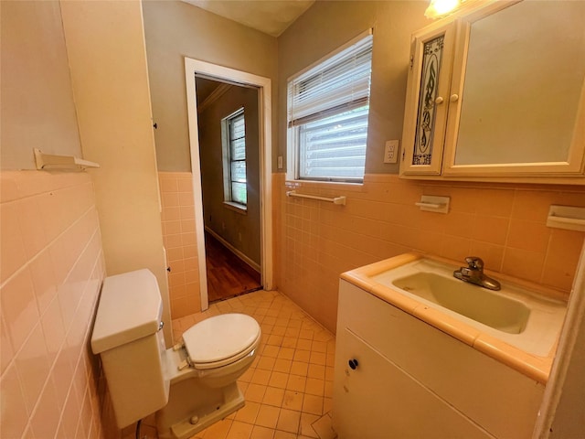 105 Longridge Dr, La Marque, TX 77568 - half bath with vanity, tile patterned floors, toilet, wainscoting, and tile walls