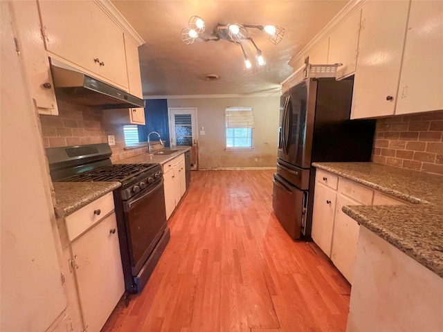 105 Longridge Dr, La Marque, TX 77568 - kitchen featuring light wood-type flooring, gas stove, crown molding, under cabinet range hood, and a sink