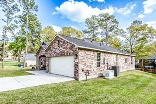 view of side of home featuring a garage, a yard, and concrete driveway