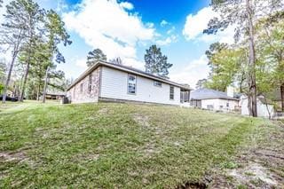 rear view of property featuring a yard