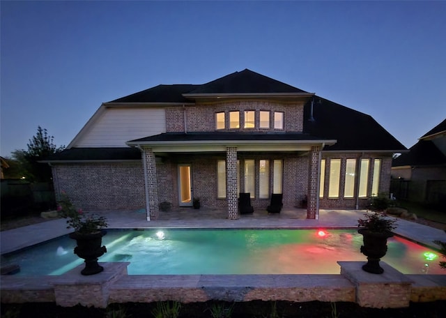 7106 Prairie Grass Ln, Katy, TX 77493 - rear view of property with brick siding and a patio area