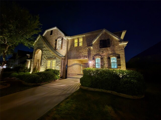 7106 Prairie Grass Ln, Katy, TX 77493 - view of front of house with a gate, stone siding, and driveway