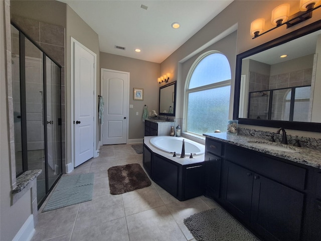 7106 Prairie Grass Ln, Katy, TX 77493 - full bathroom featuring a shower stall, tile patterned floors, a bath, baseboards, and two vanities